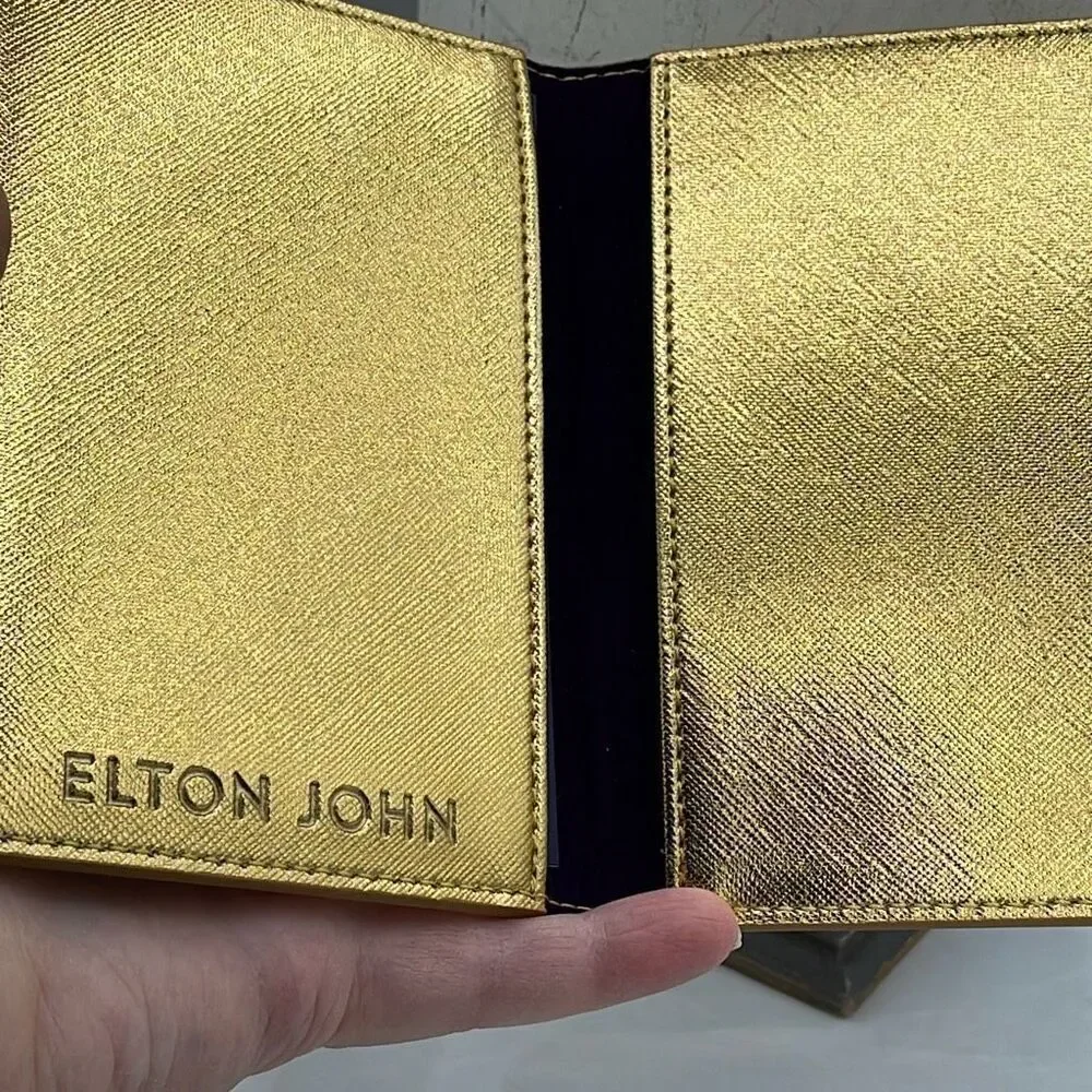 Vintage Elton John gold colored passport cover.